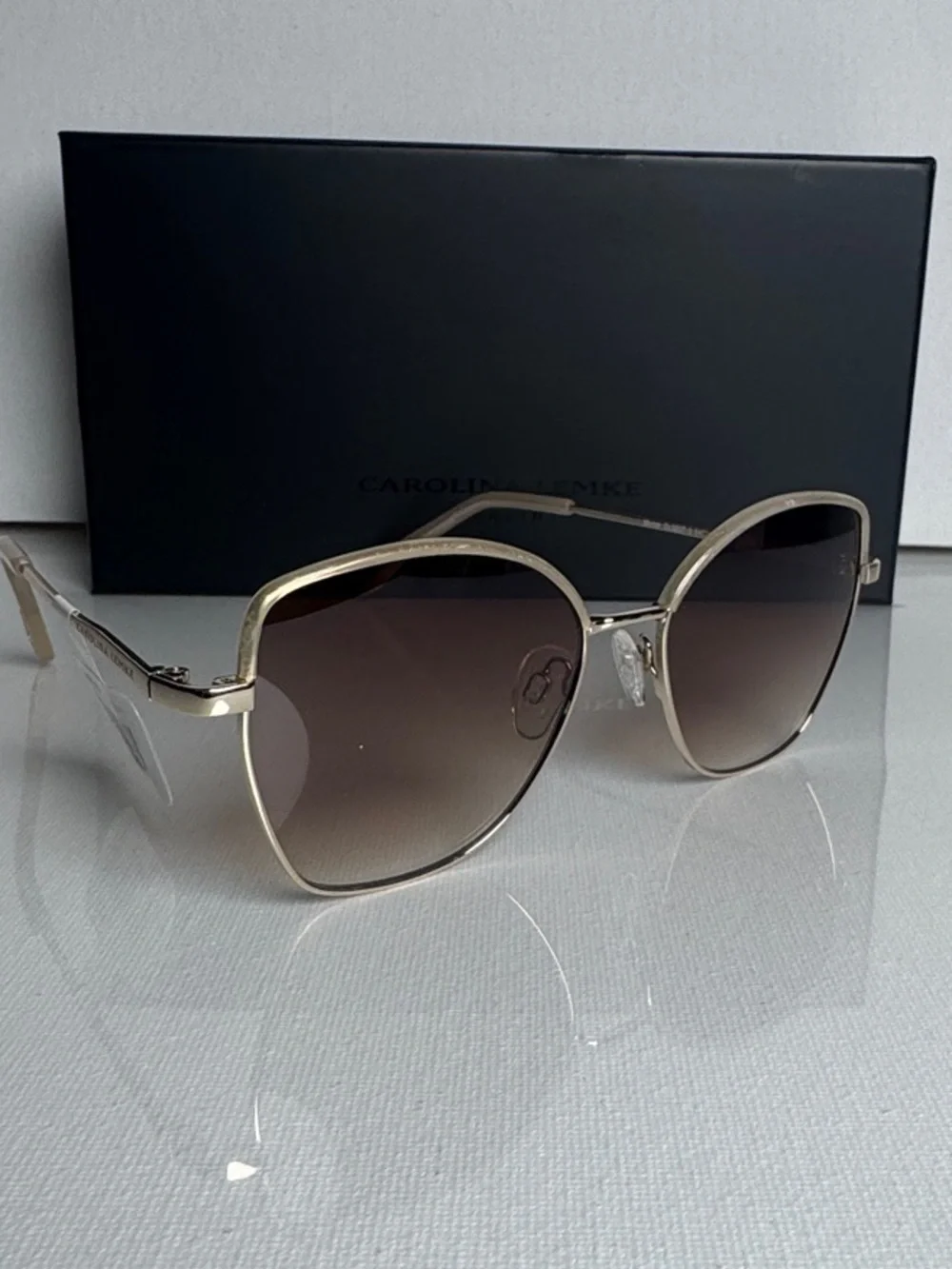 Carolina Herrera Gold Frame Sunglasses with Brown Gradient Lenses